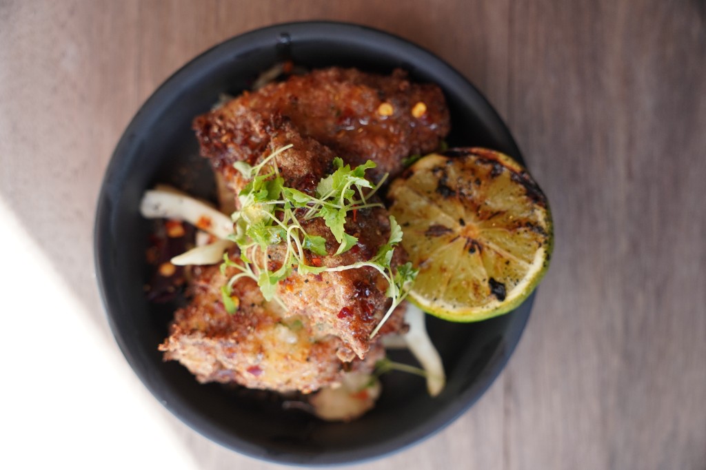 Crispy fried chicken bites with hot honey glaze and charred citrus
